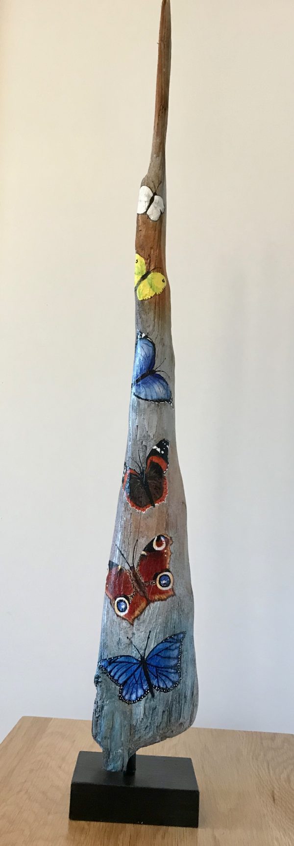 Driftwood with butterflies painted on